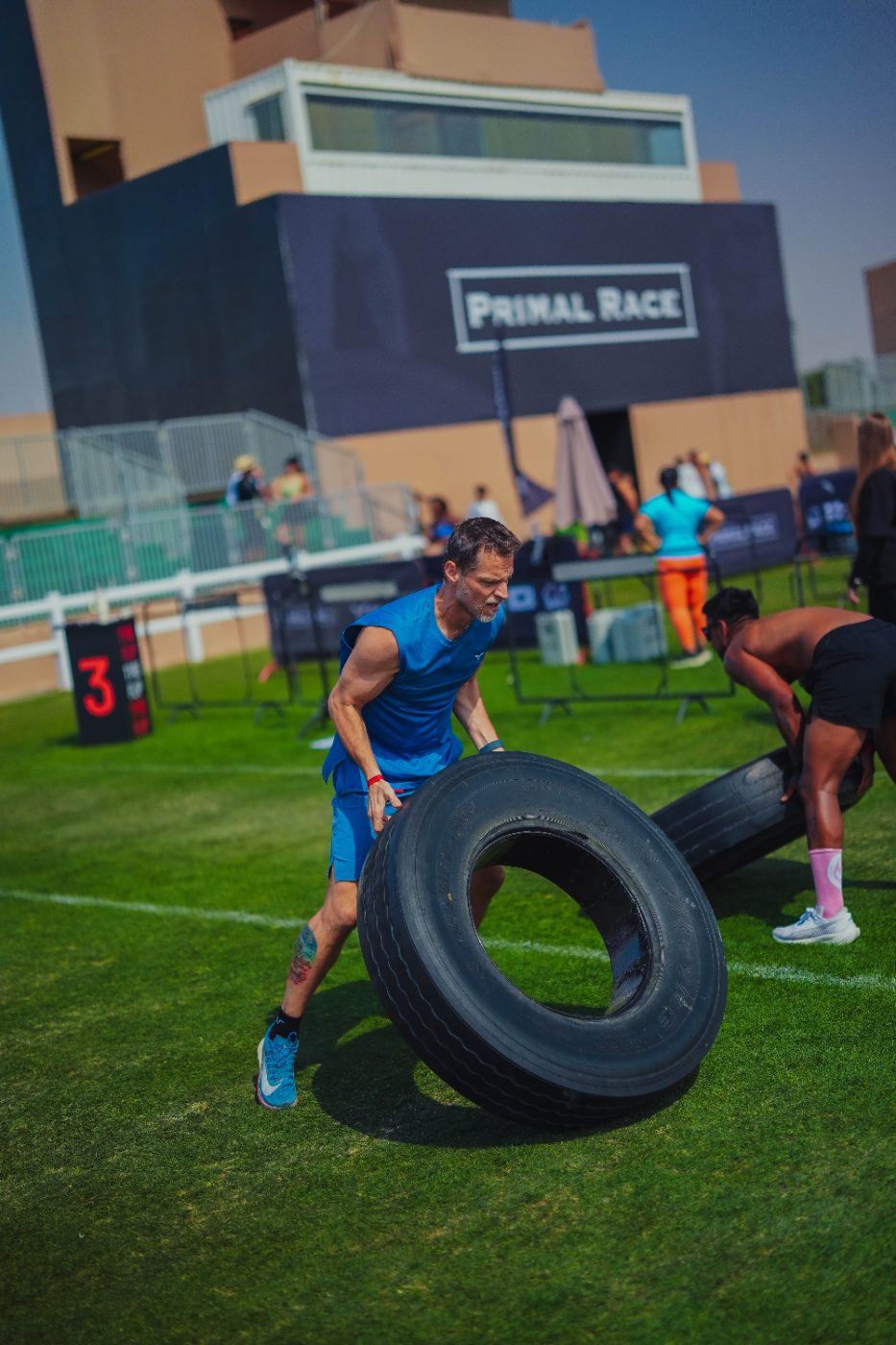 An athlete flipping a tyre at a Primal race