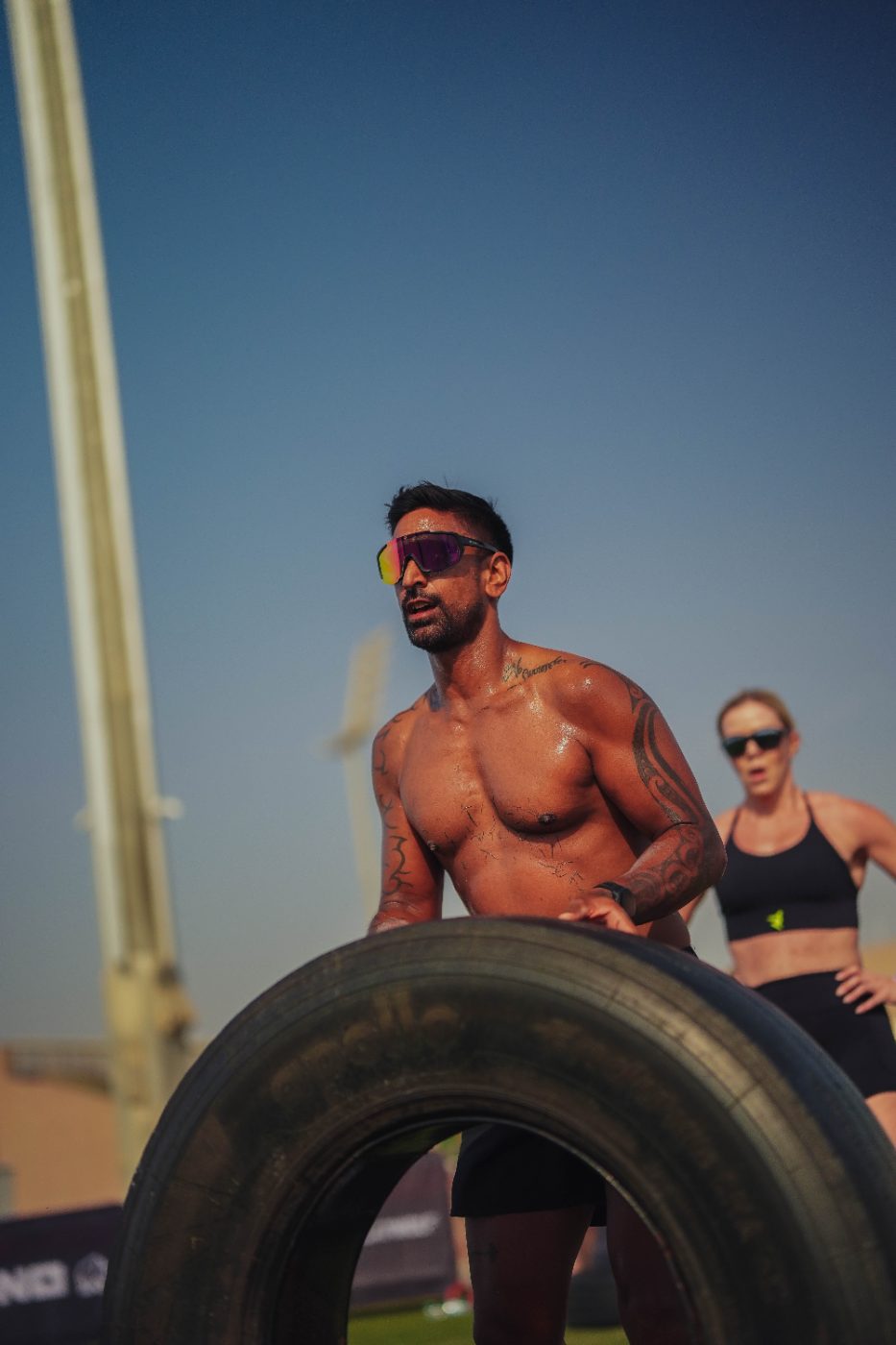 An athlete setting up on the tyre flip at a Primal race