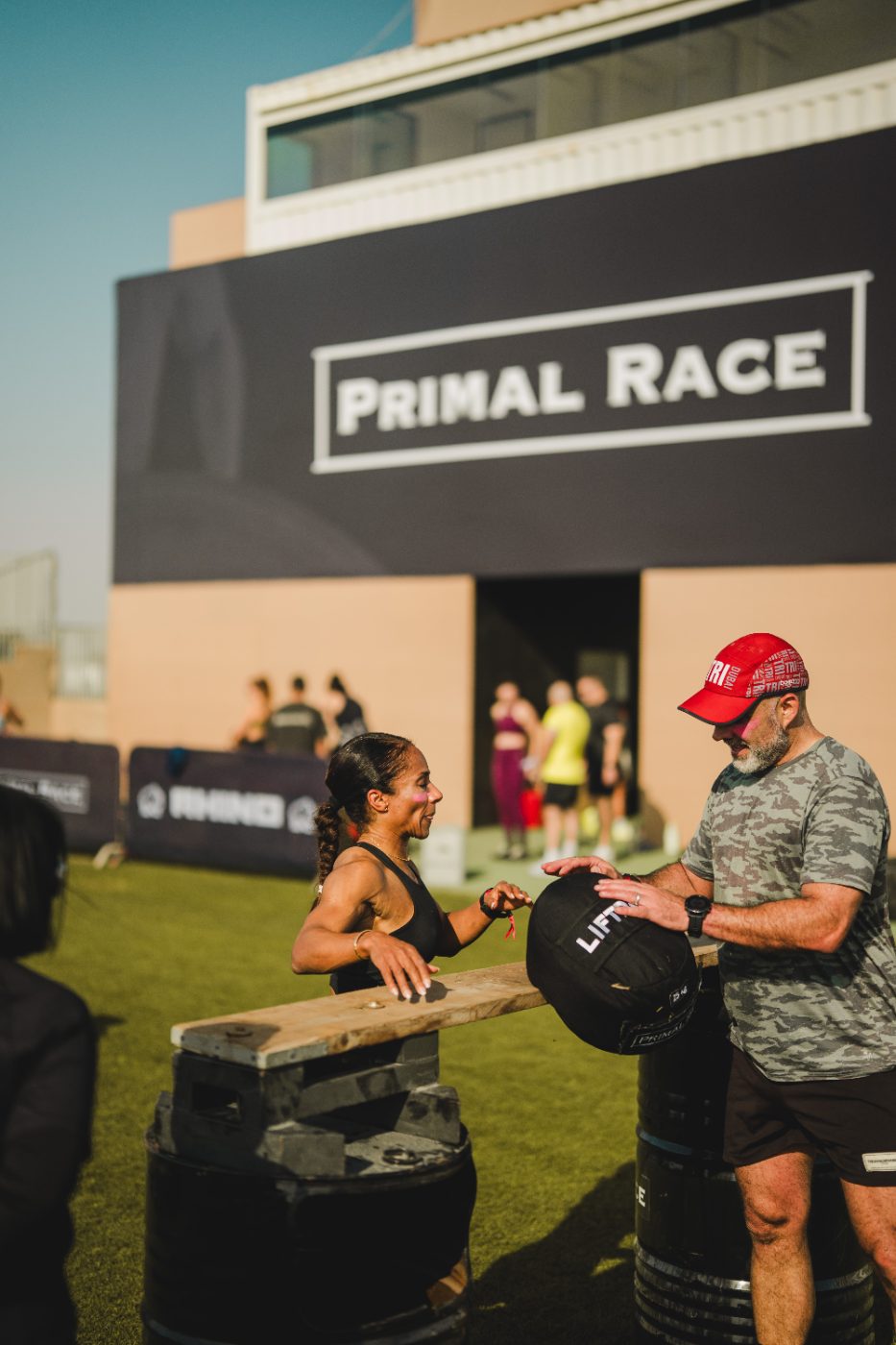 An athlete at the sandbag in front of the Primal Race boards