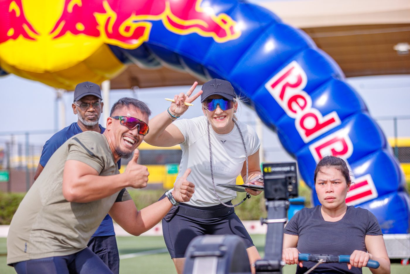 Judges beside an athlete on the row at a Primal race