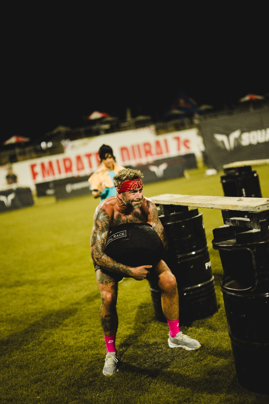 An athlete carrying a Primal Race sandbag