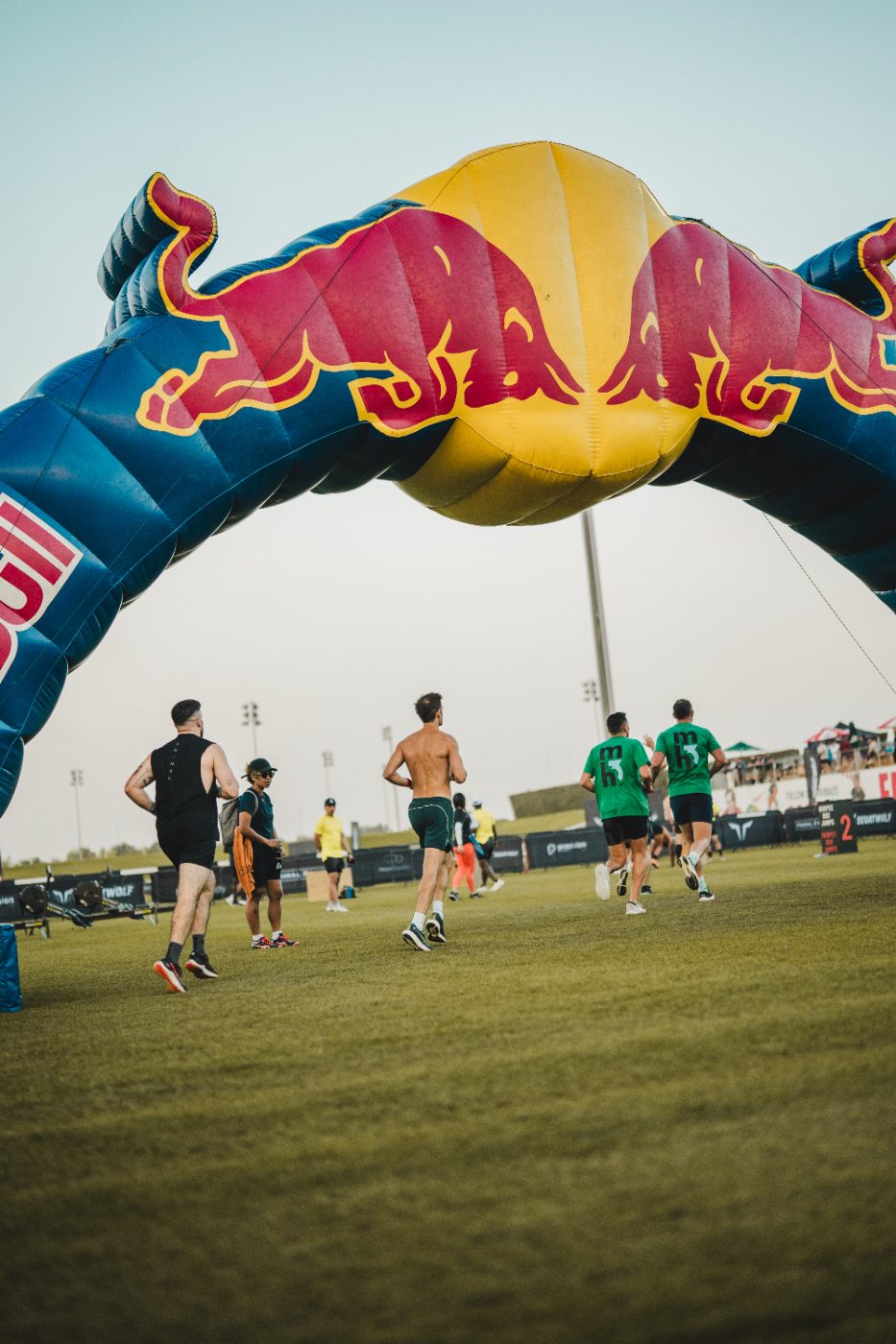 Athletes running the loop past the arch at a Primal race